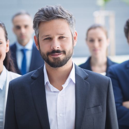 confident-businessman-with-colleagues-min confident-businessman-with-colleagues-min
